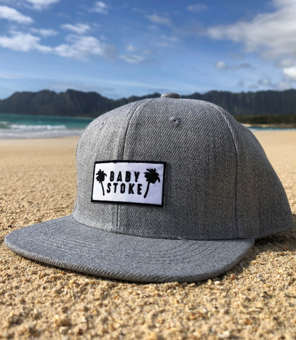 Grey Palm tree hat for toddlers on the beach in the sand in hawaii on an adventure provides protection from the sun copy