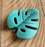 Load image into Gallery viewer, Tropical teething leaf toy with textures to help your baby with teething, green fun toy
